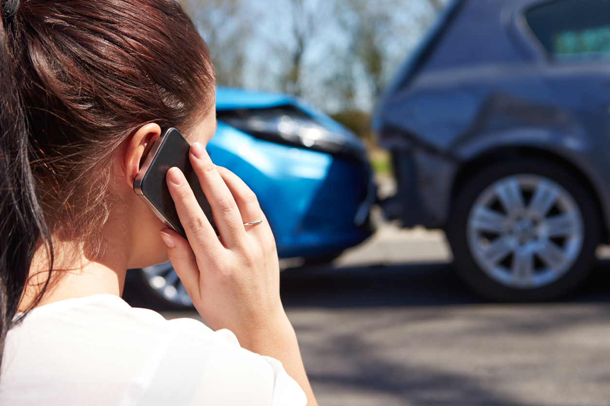 Female driver making a phone call after an accident