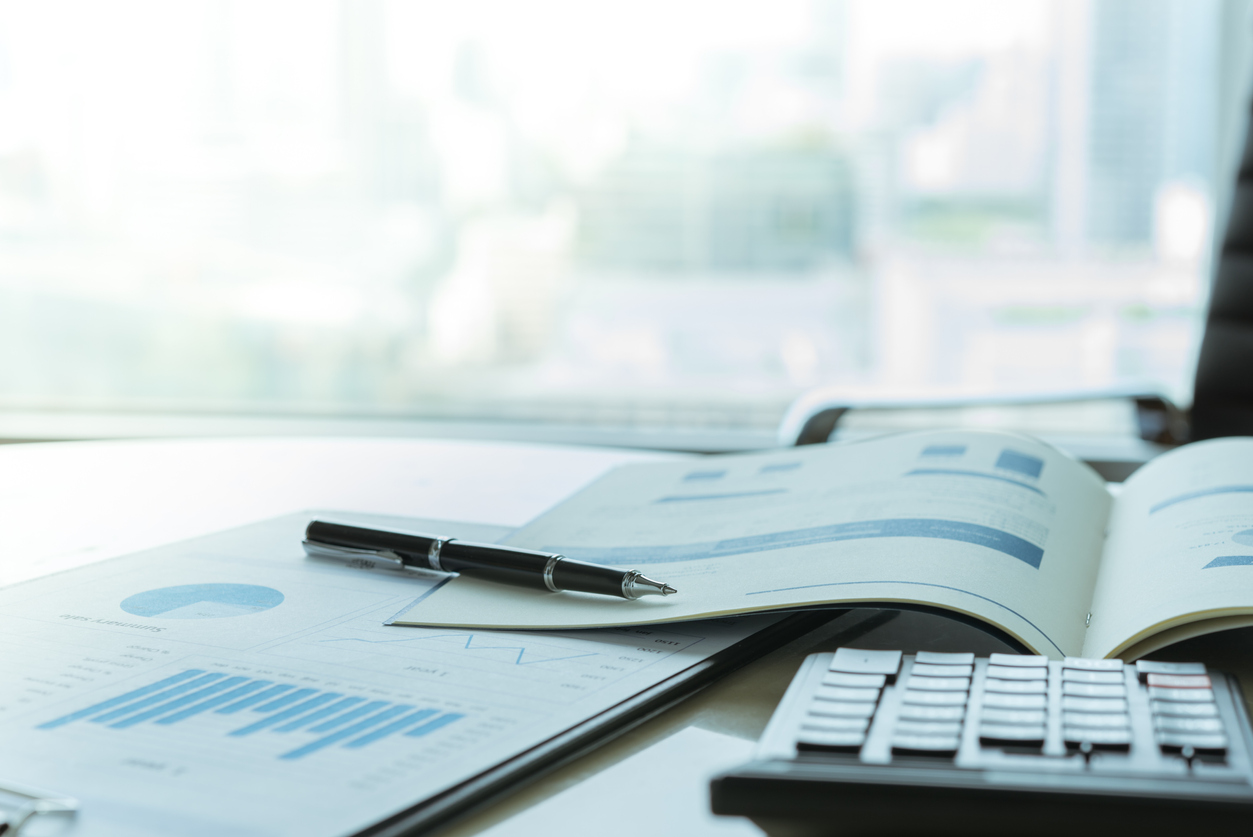 Financial reports and calculator on an office desk