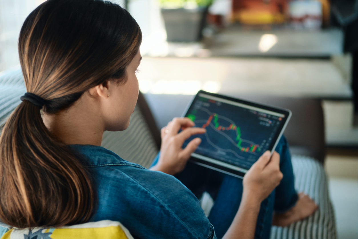 Young woman using trading app on tablet