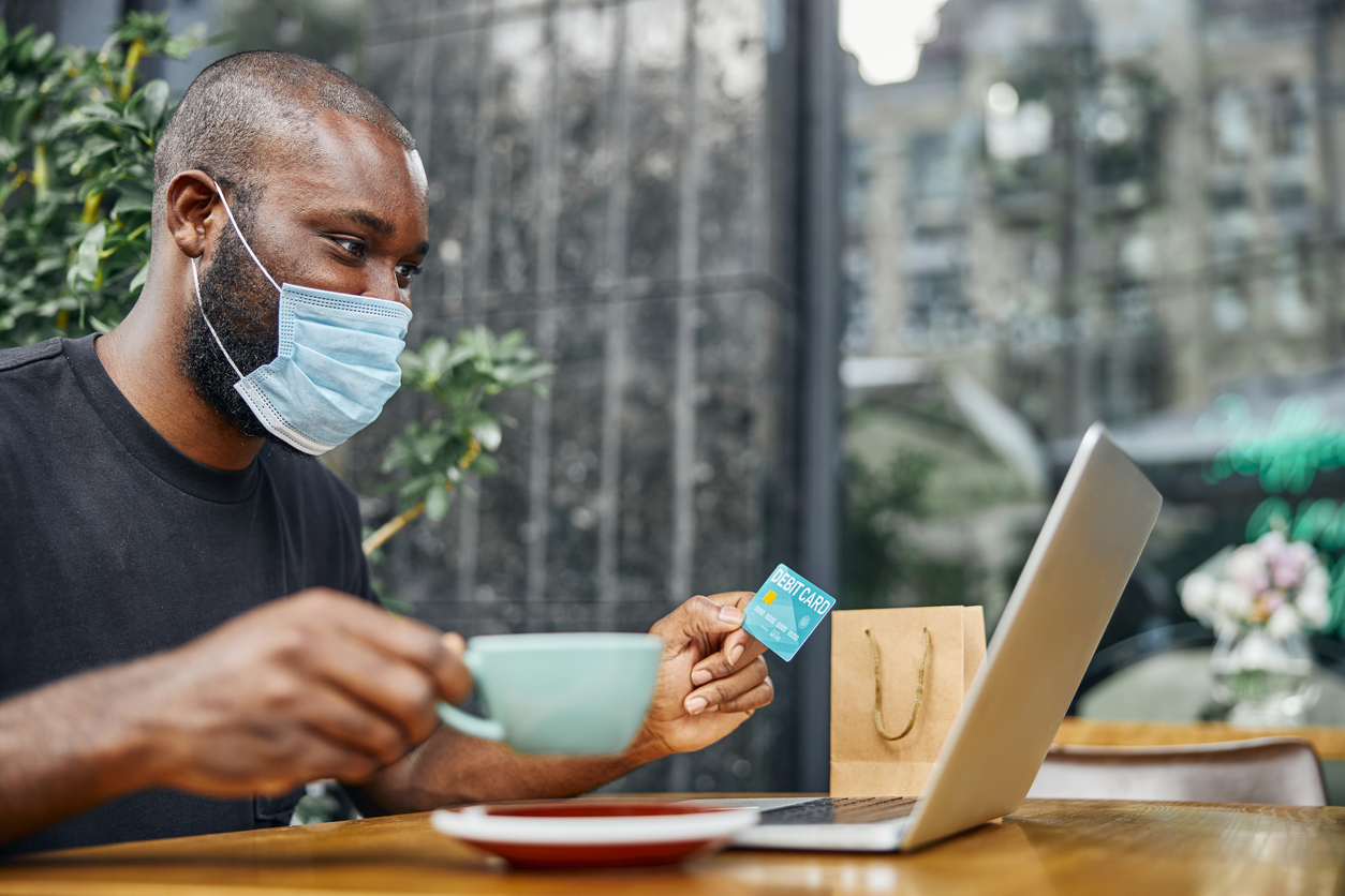 Masked African-American man making digital payment