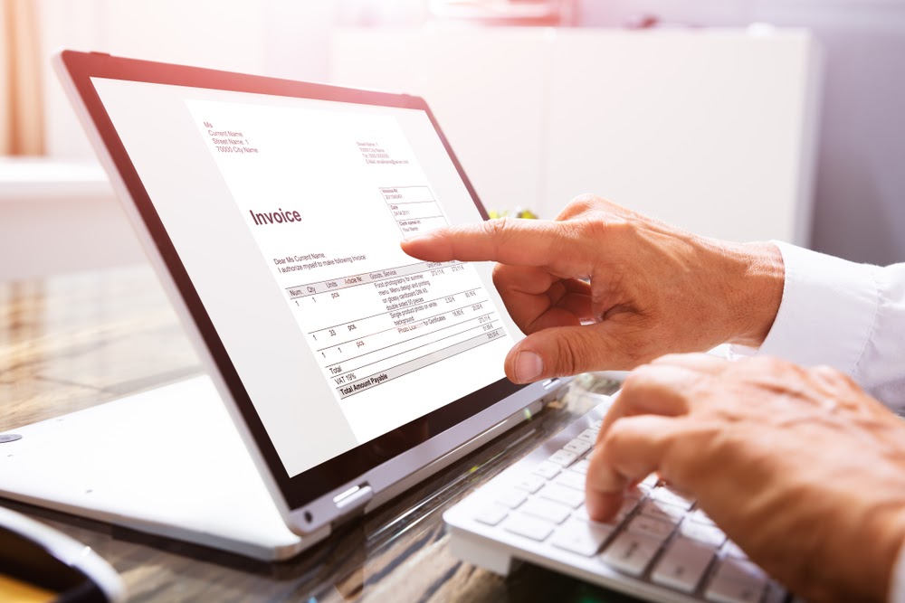 Older man reading invoice on tablet screen