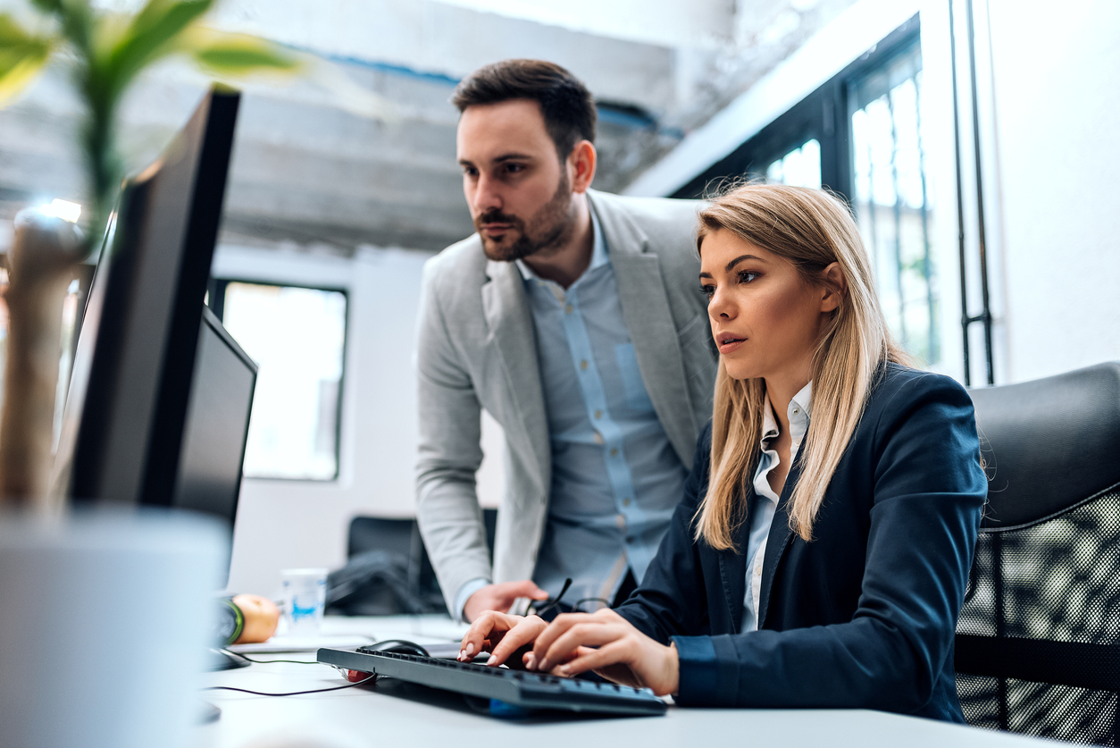 Two businesspeople trading digitally