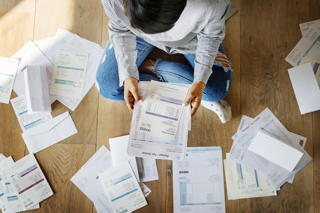 Woman looking over bills and invoices