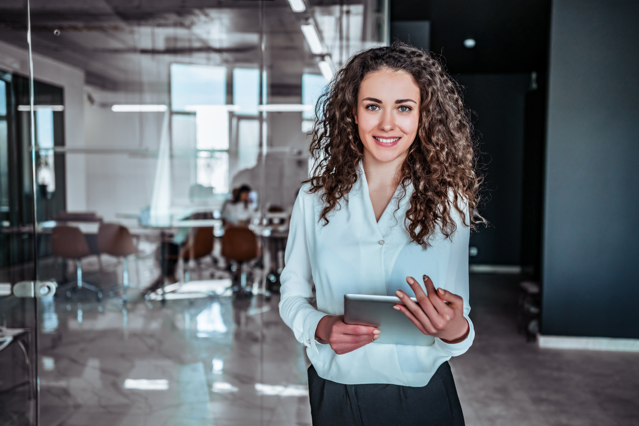 Businesswoman holding tablet in a modern office