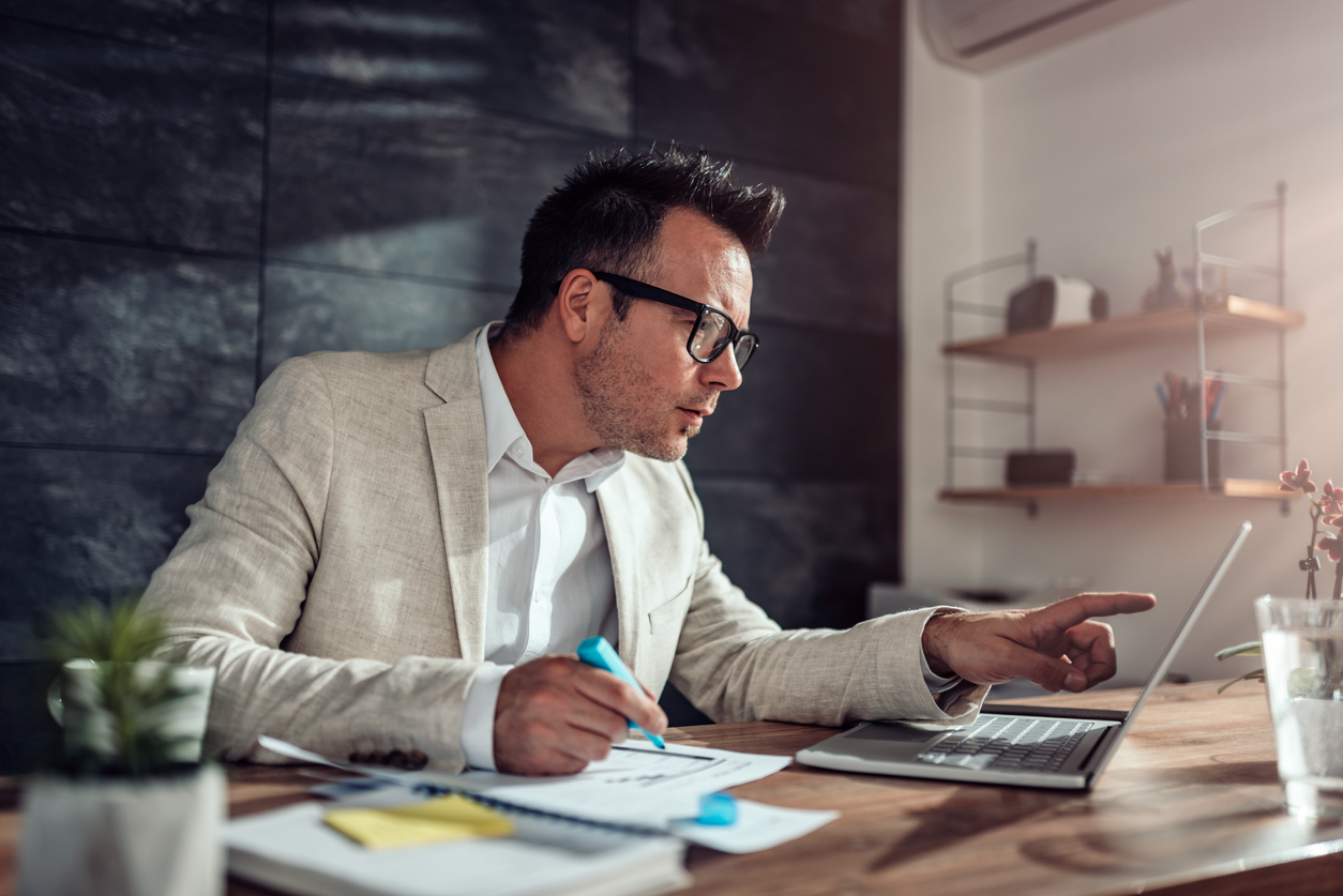 Accountant in white suit working from home office