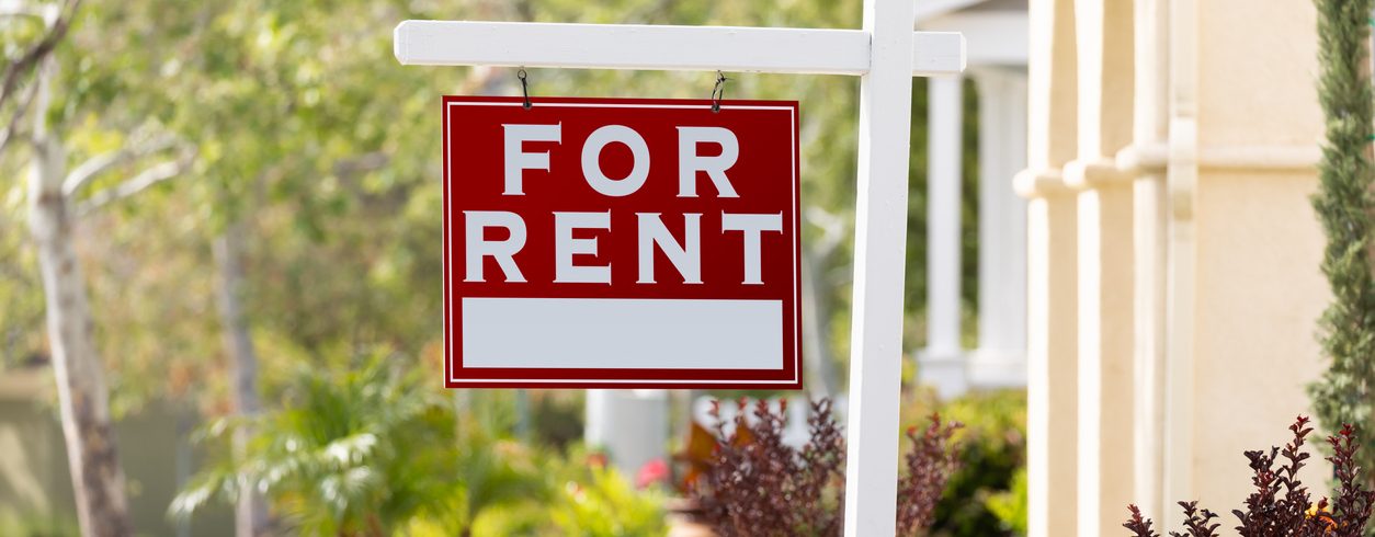 For Rent sign in front of an apartment complex