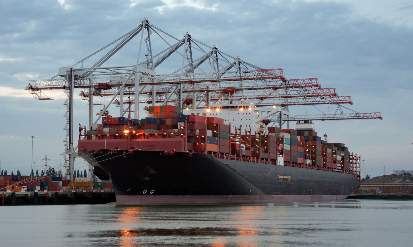 Large container ship in port being unloaded