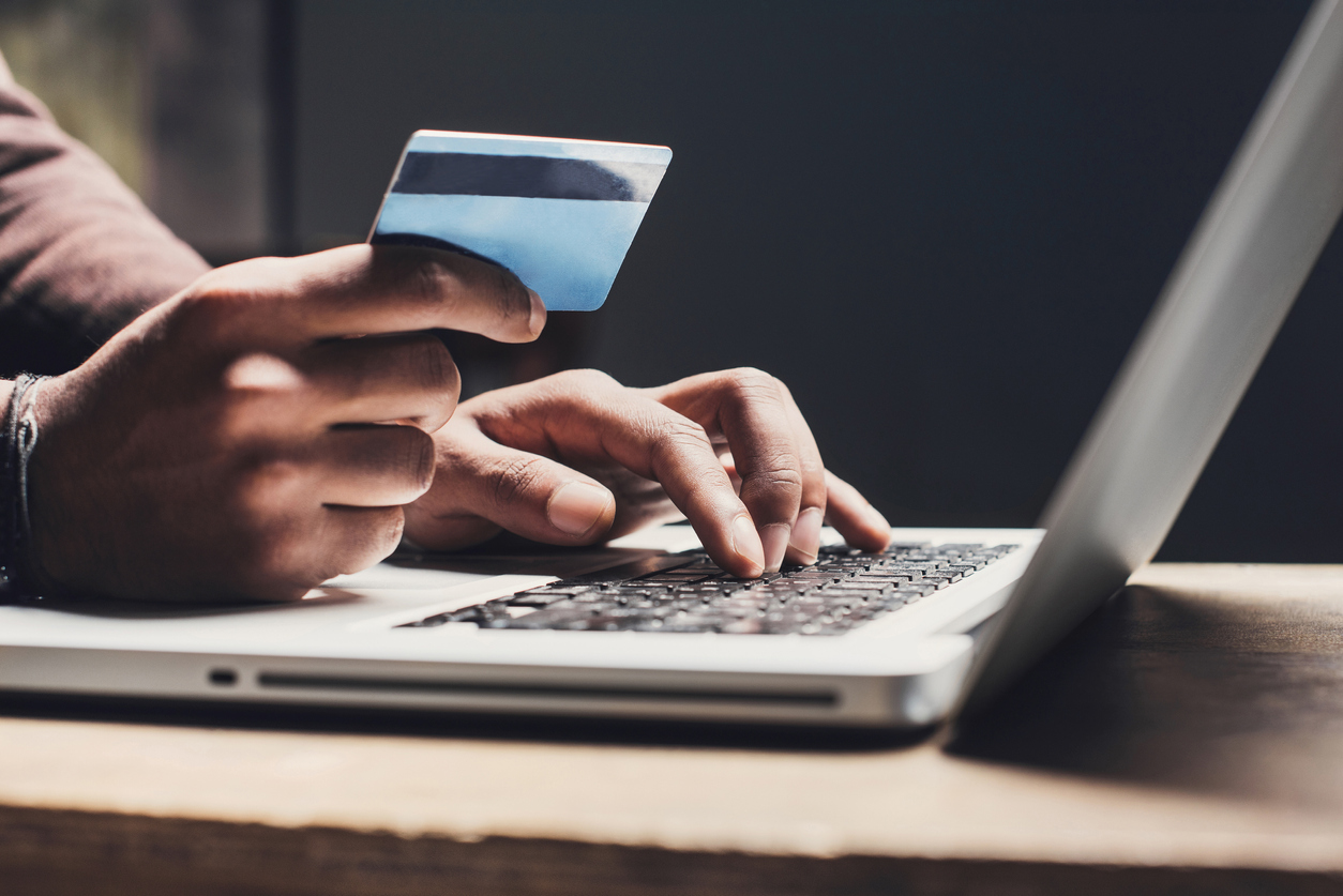 Man shopping online with a laptop and credit card