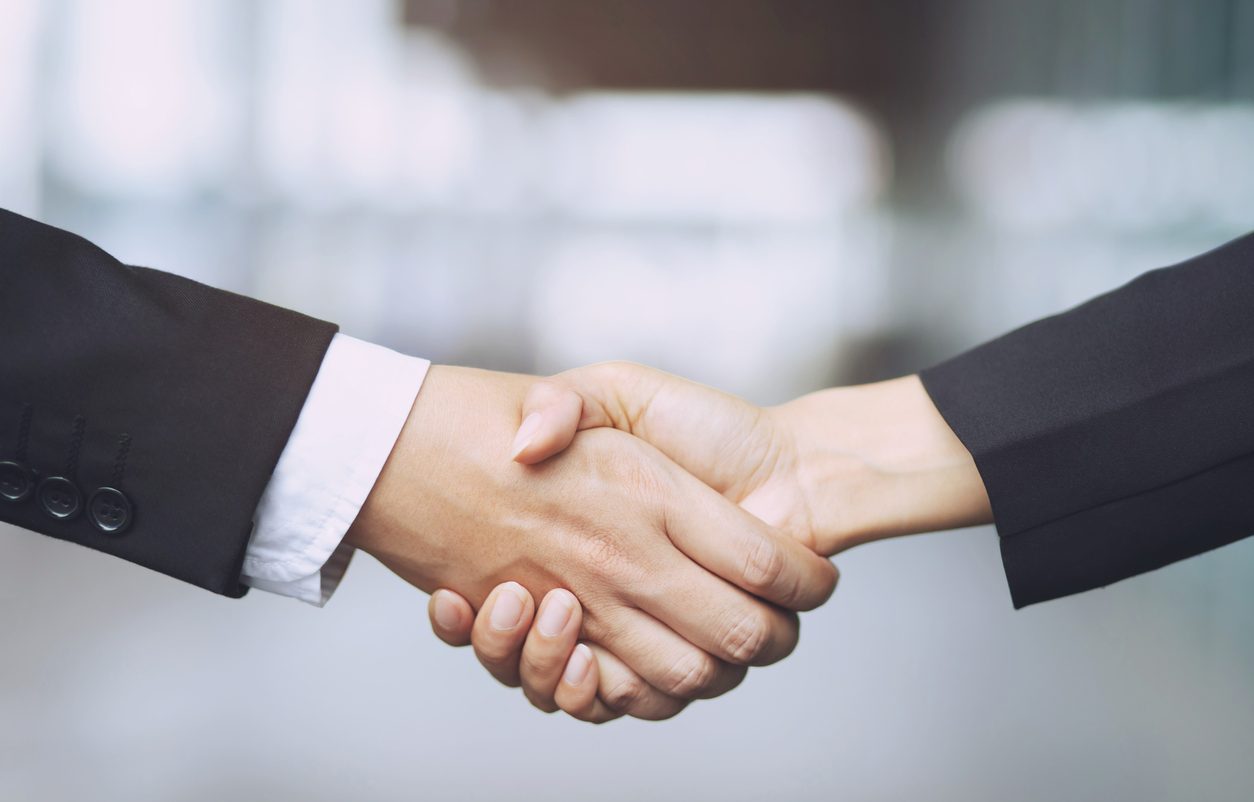 Businessman and businesswoman shaking hands