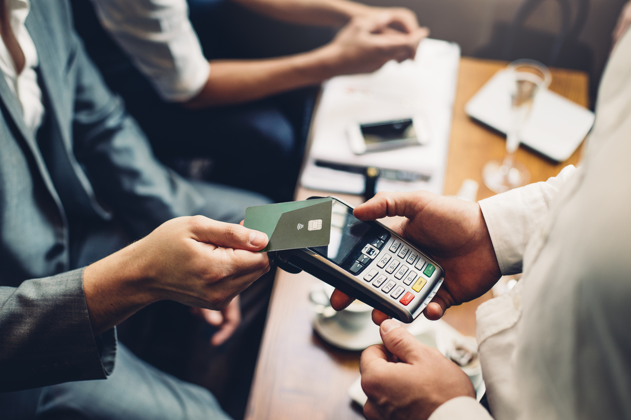 Businessman in cafe making contactless payment