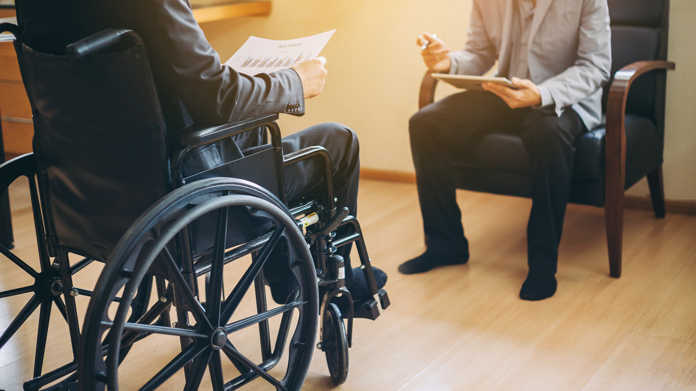 Man in a wheelchair meeting with his employer