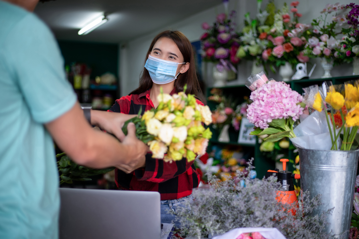 Small business owner serving customer amid pandemic