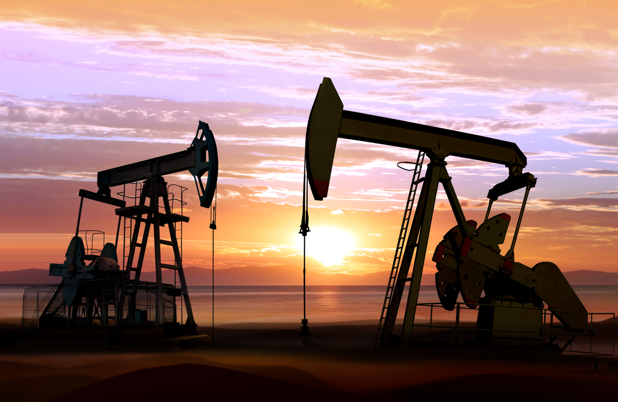 Oil pumps against sunset