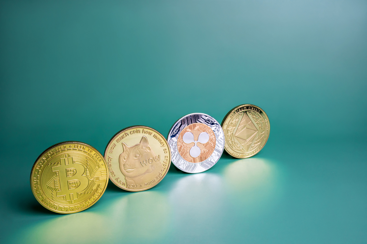 Bitcoin, Ripple XRP, Dogecoin, Ethereum cryptocurrency on green background