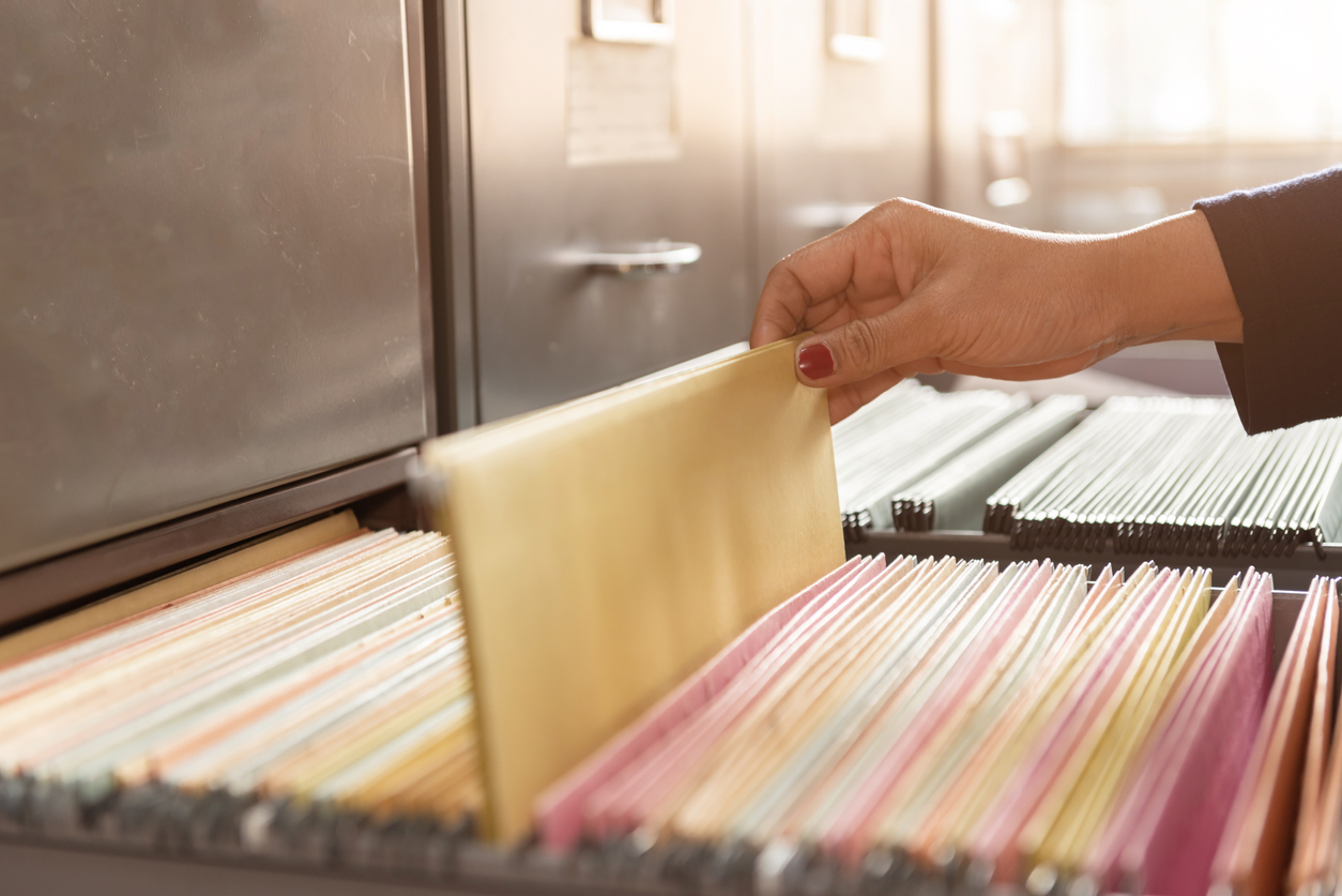 Paper documents in filing cabinet