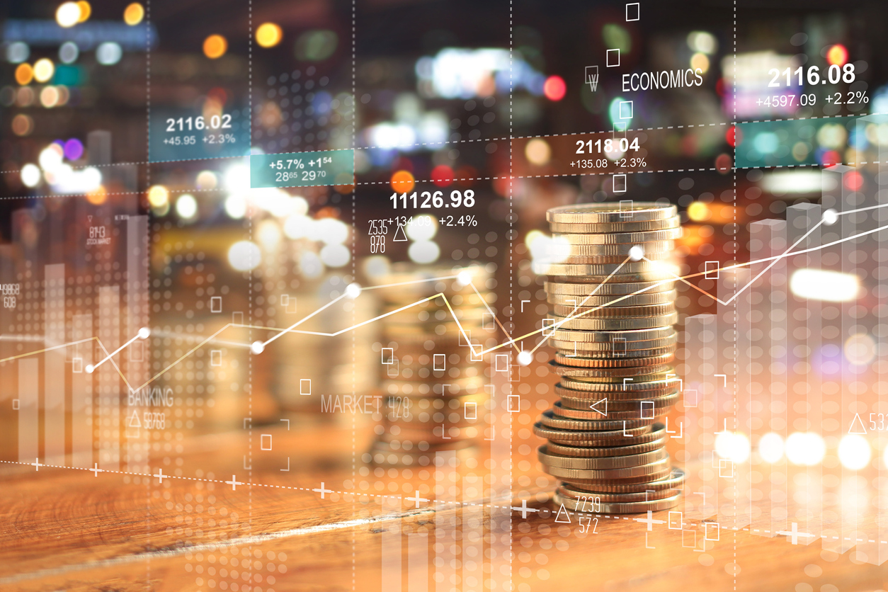 Stacks of coins against investment graph