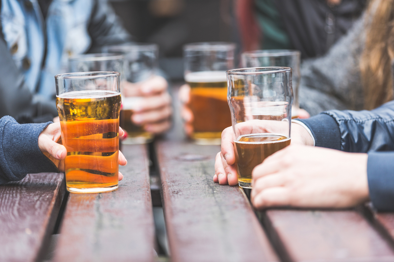 People drinking at pub, UK.