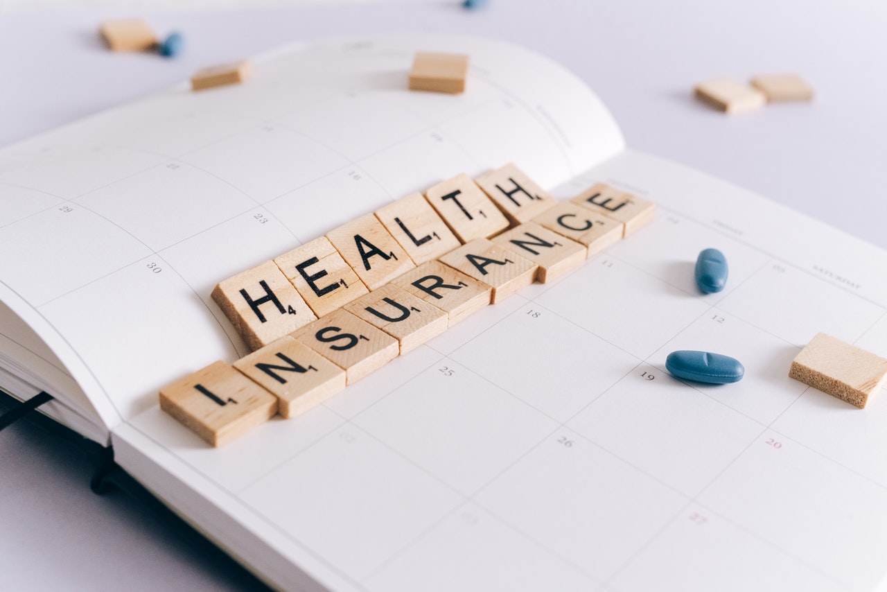 Health insurance spelt order with Scrabble letters