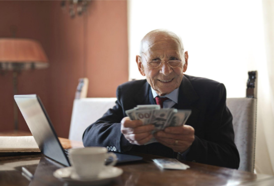 Retired man looking at cash