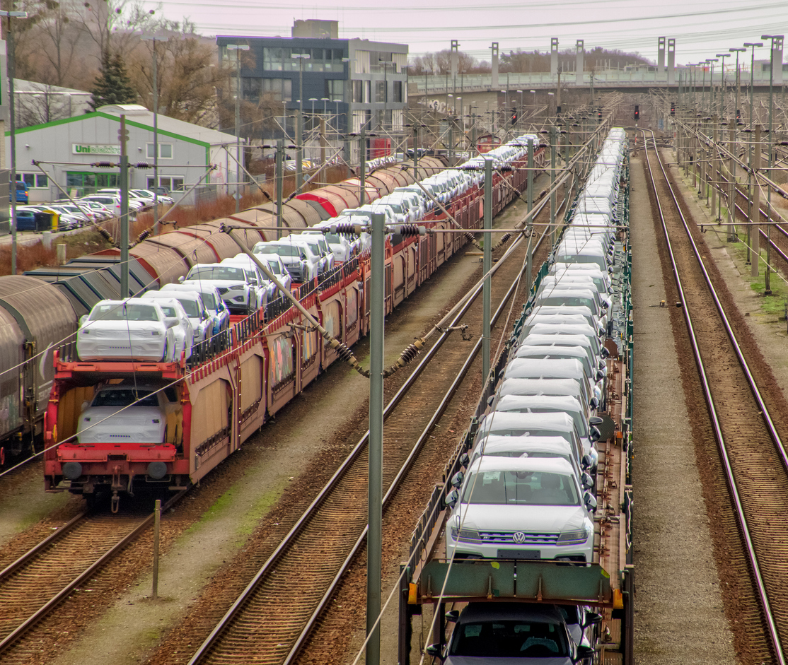 Transfer yard in Fallersleben with freight trains loaded with new Volkswagen cars and waiting to be transported away