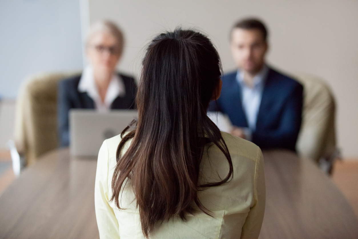 Businesswoman and businessman HR manager interviewing woman