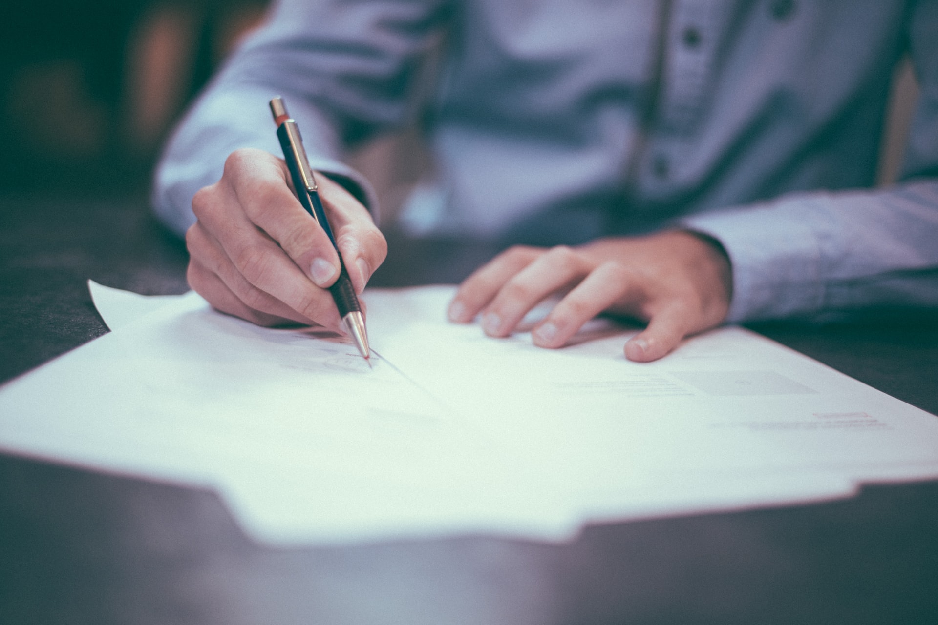 Man filling out forms for estate planning