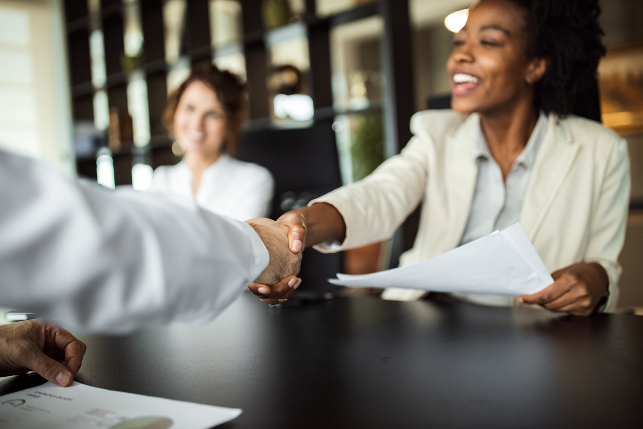 Female investor shaking hands in meeting