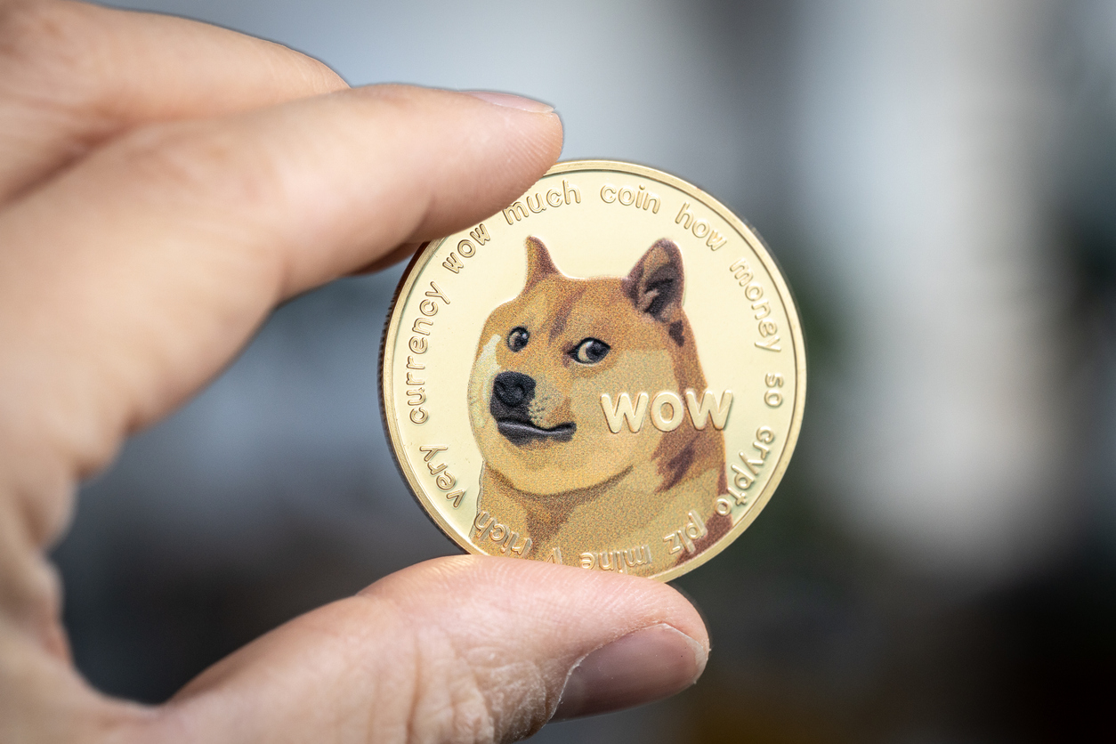 Dogecoin held between two fingers