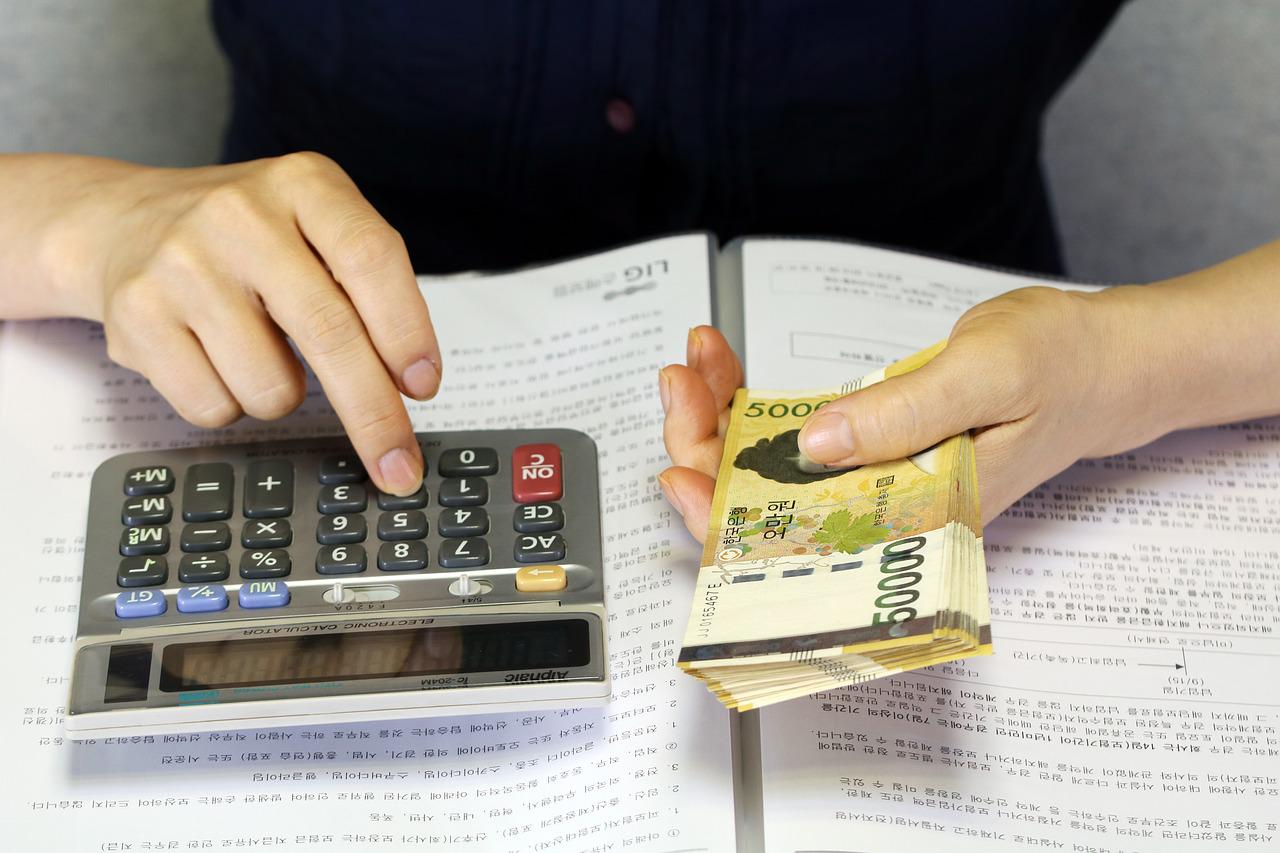 Person working out business budget on calculator