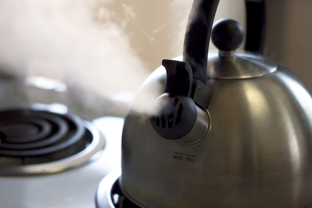 A close up of steaming tea kettle