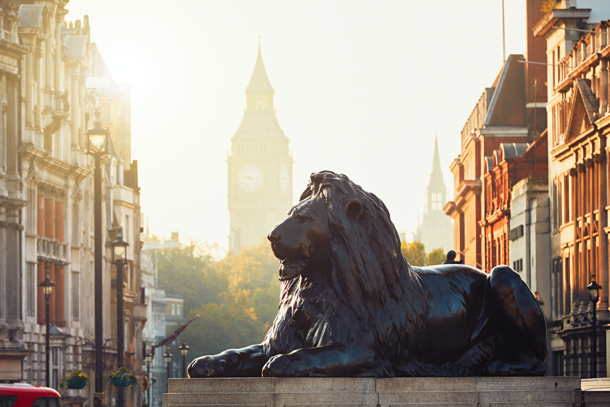 London; statue of Lion in front of outline of Big Ben