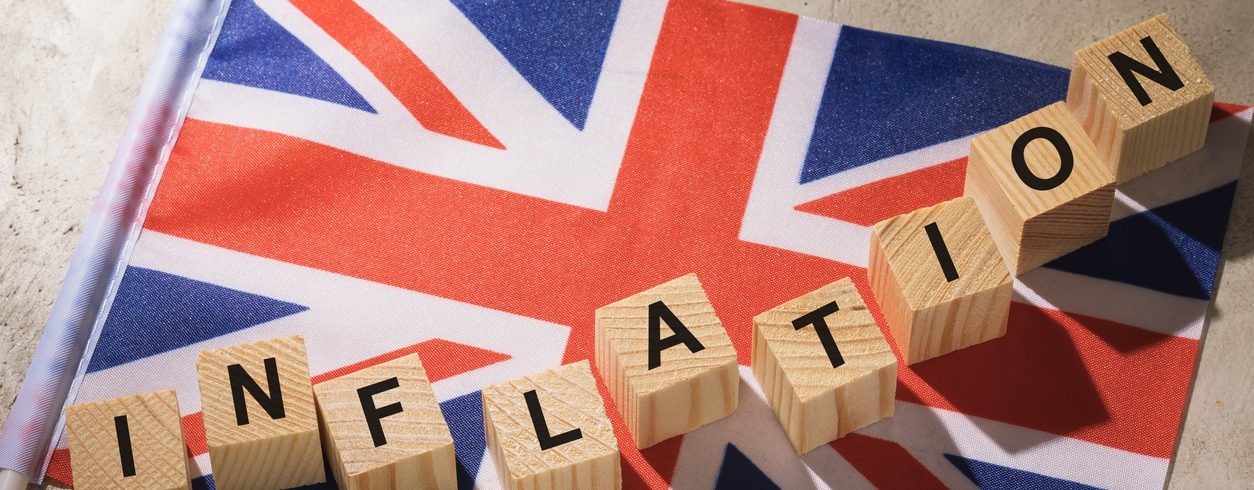 Britain flag and wooden cubes with text, concept on the theme of inflation,