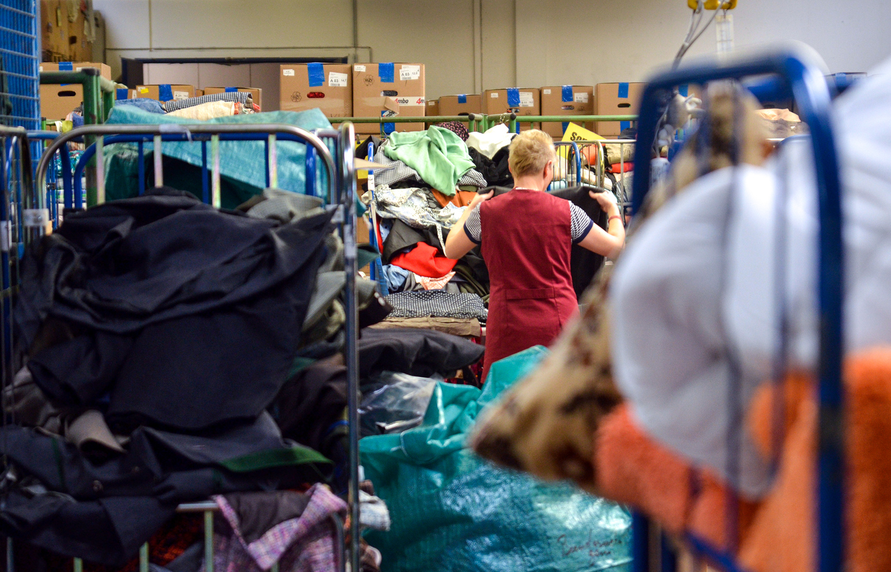 Woman organises donations at a charity shop