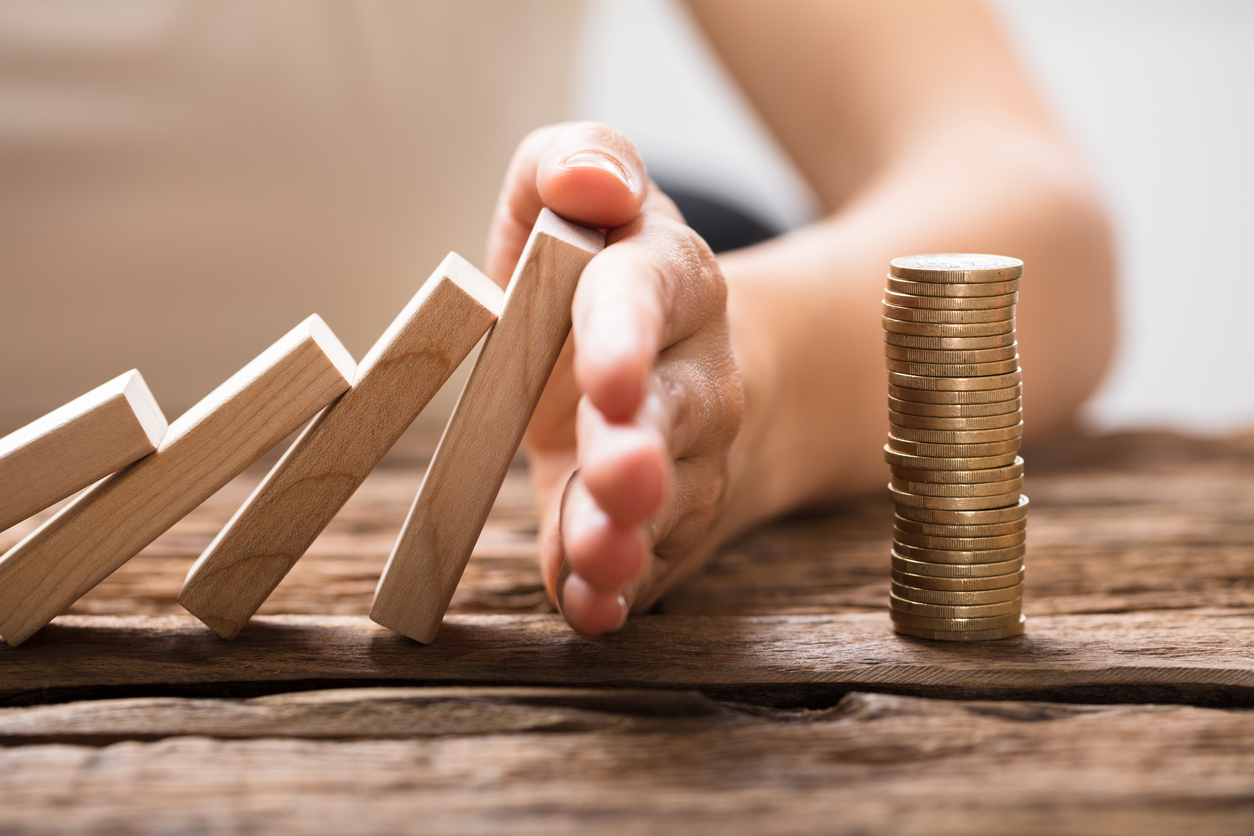 Close-up Of A Businesswoman's Hand Stopping Falling Blocks