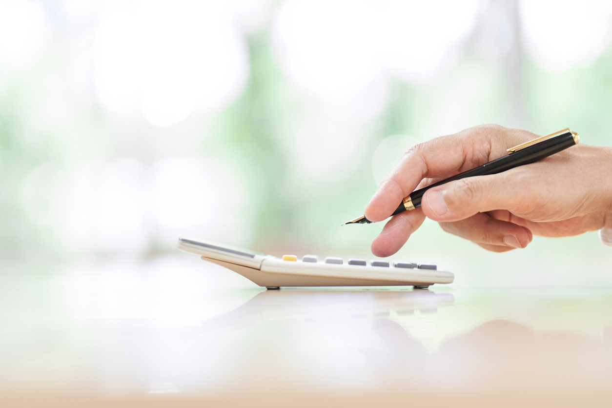 Person working out personal financial plan on calculator