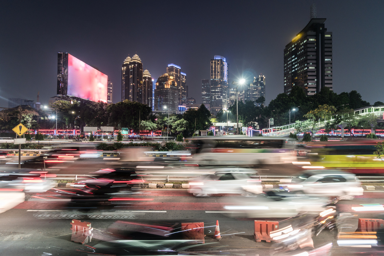 Emerging market; cars blurred across dark street