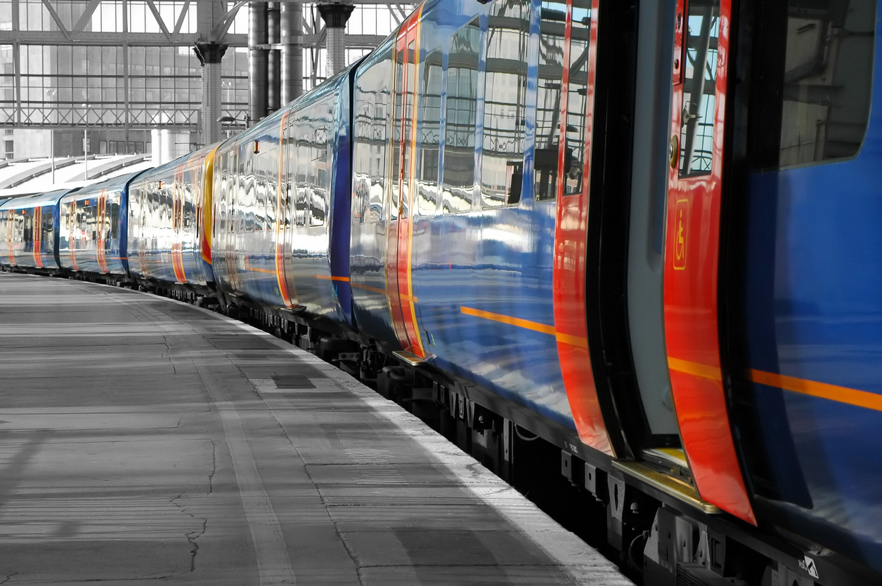 Train pulled up in station with open doors