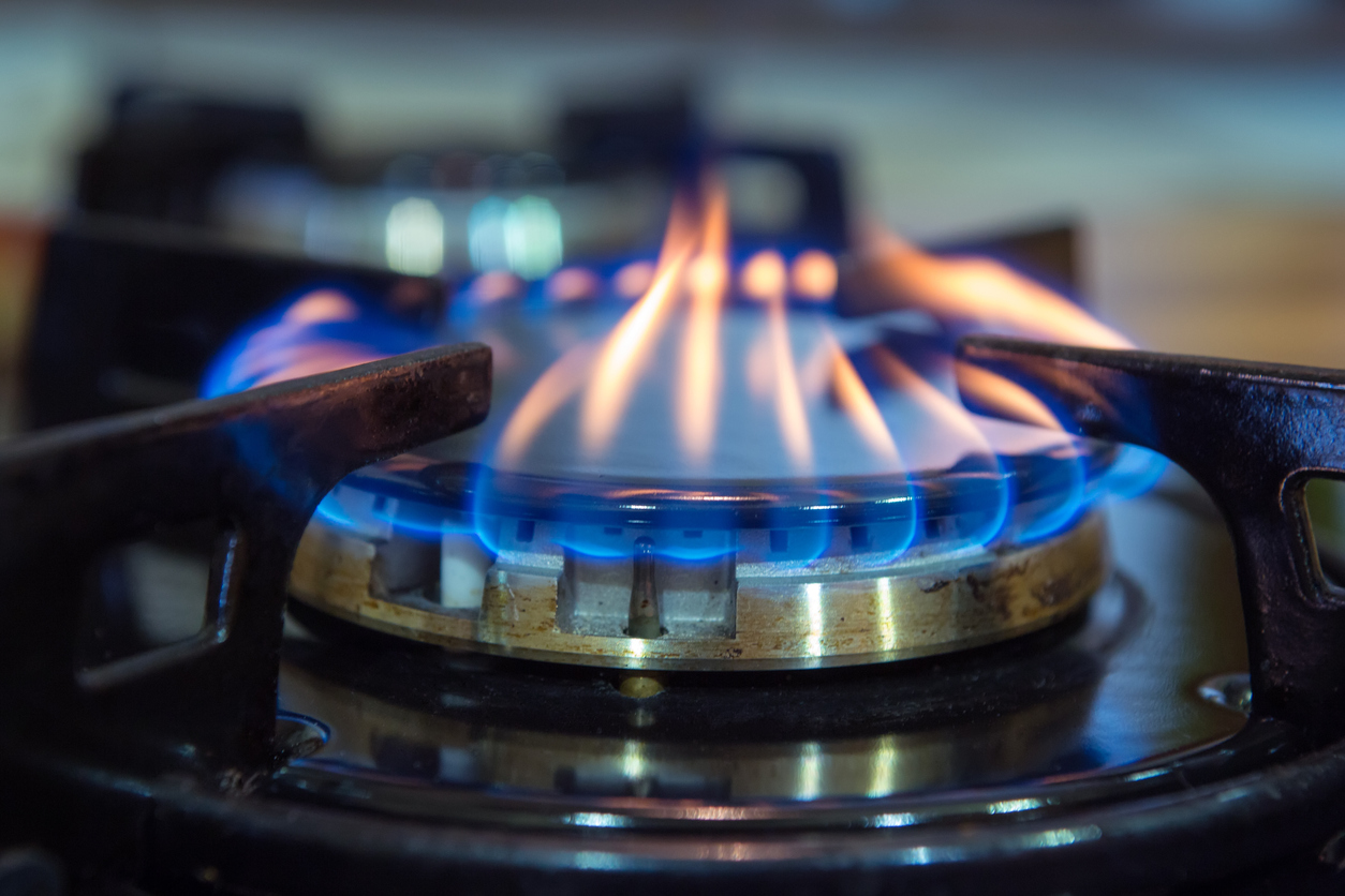 Blue flames on gas stove burner.