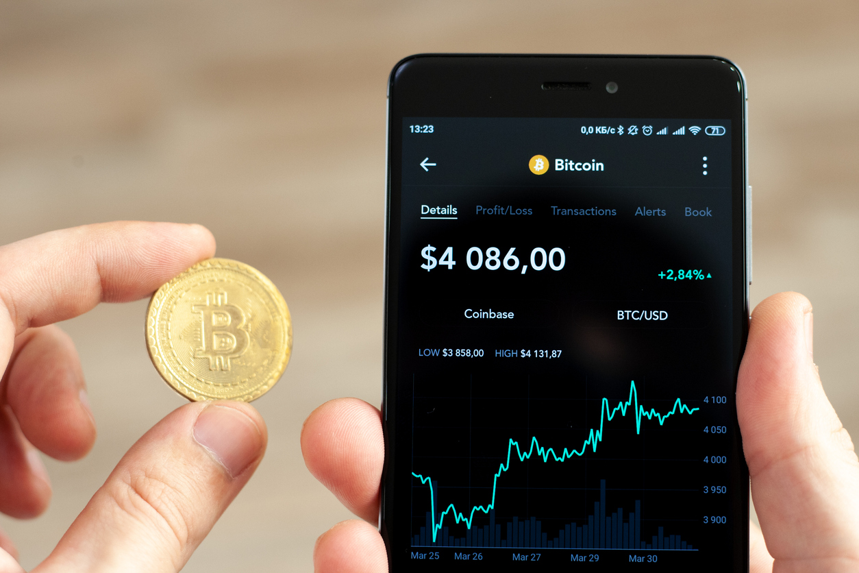 Hands holding a smartphone with bitcoin exchange rate