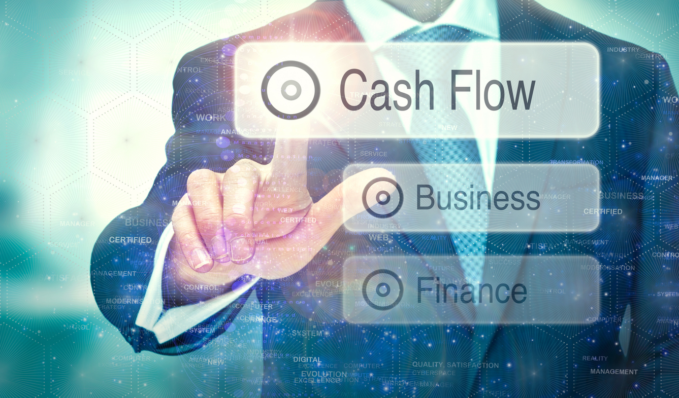 A businessman selecting a button on a futuristic display with a Cash Flow concept written on it.