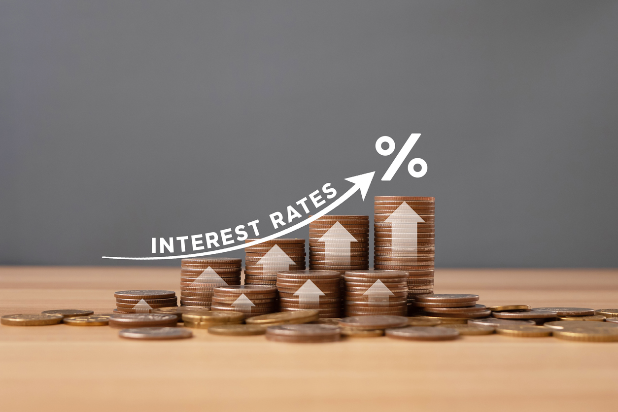 stacked of coins on table with percentage icon and gray background with illustration shows increasing of interest rates / financial concept.