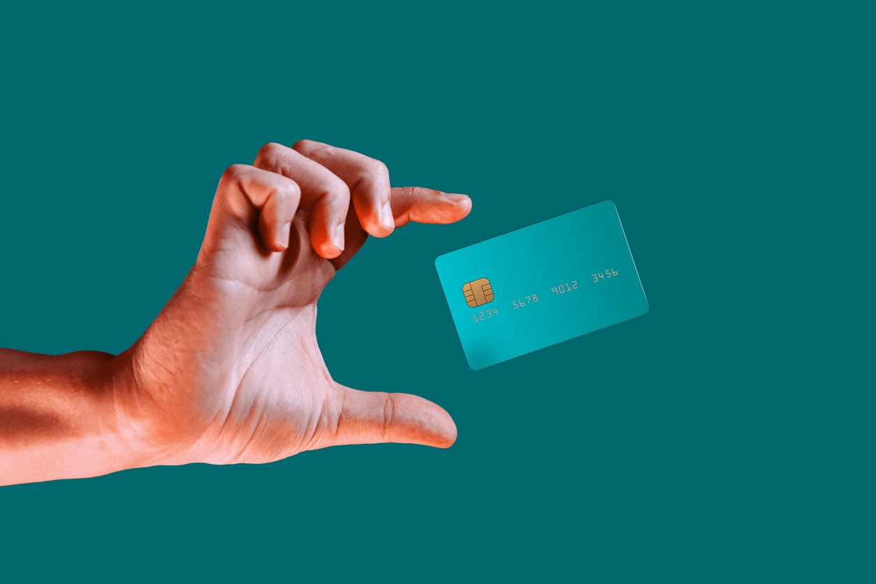 close up male hand and levitating template mockup bank credit card with online service isolated on green background