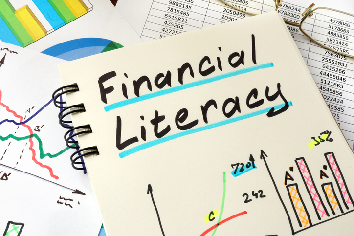 financial literacy written on a notepad sheet. education concept.