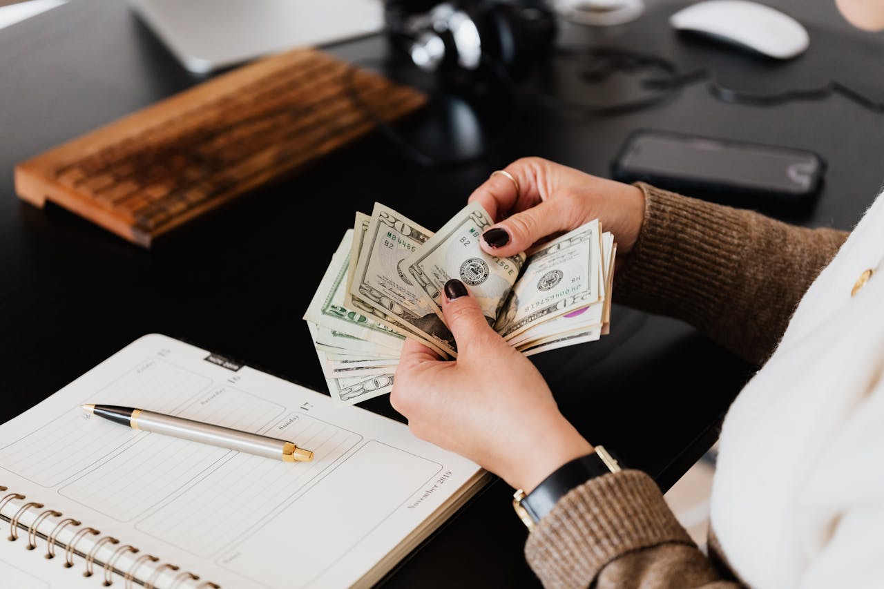 Person counting money after a settlement.