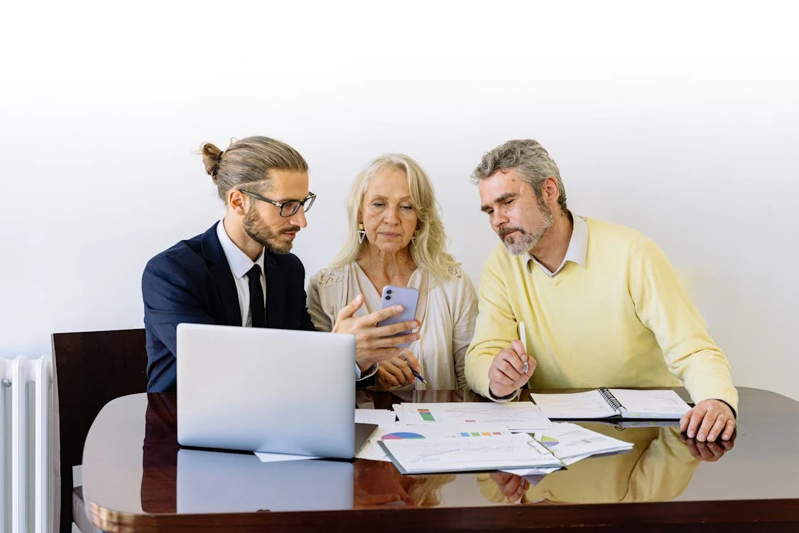 a financial advisor talking to an older couple about managing property.