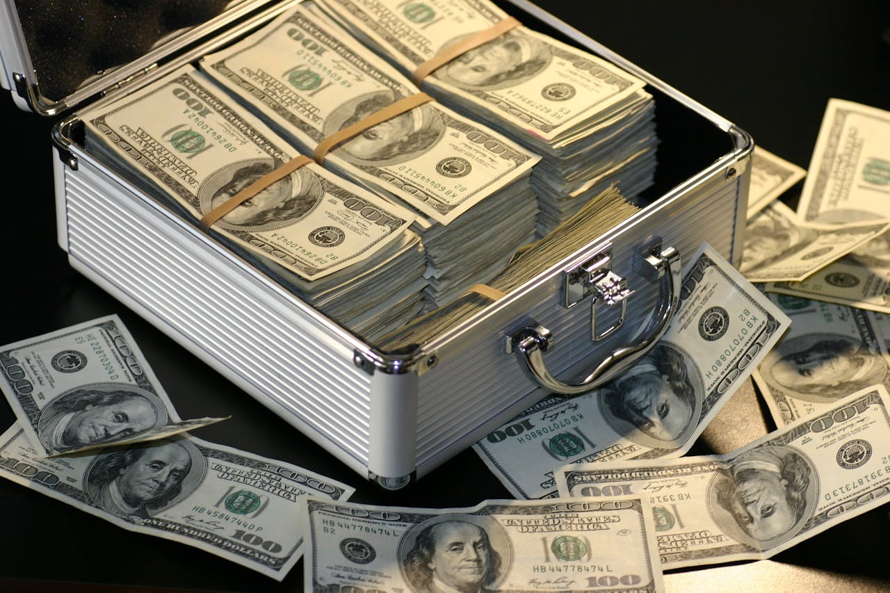 Pile of dollar bills in a briefcase.