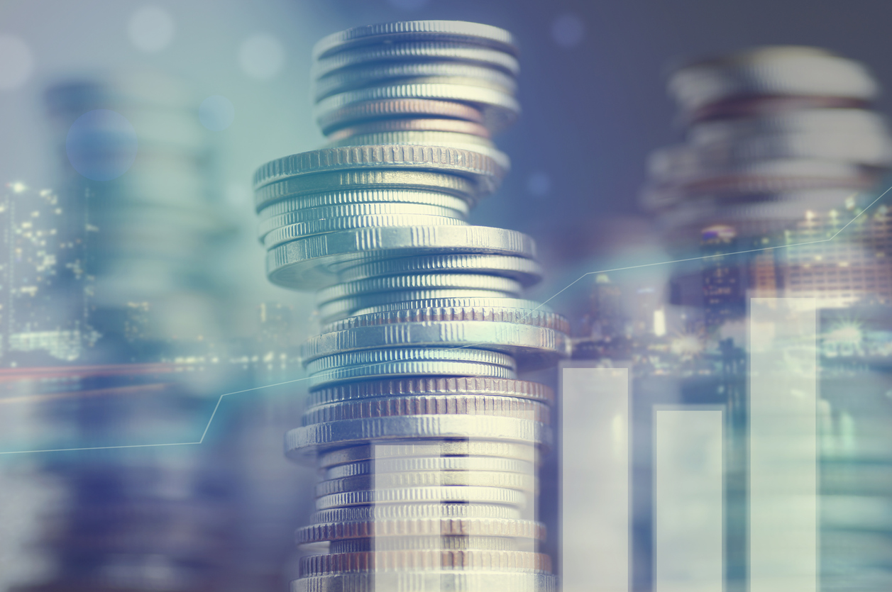 double exposure of city and graph on rows of coins