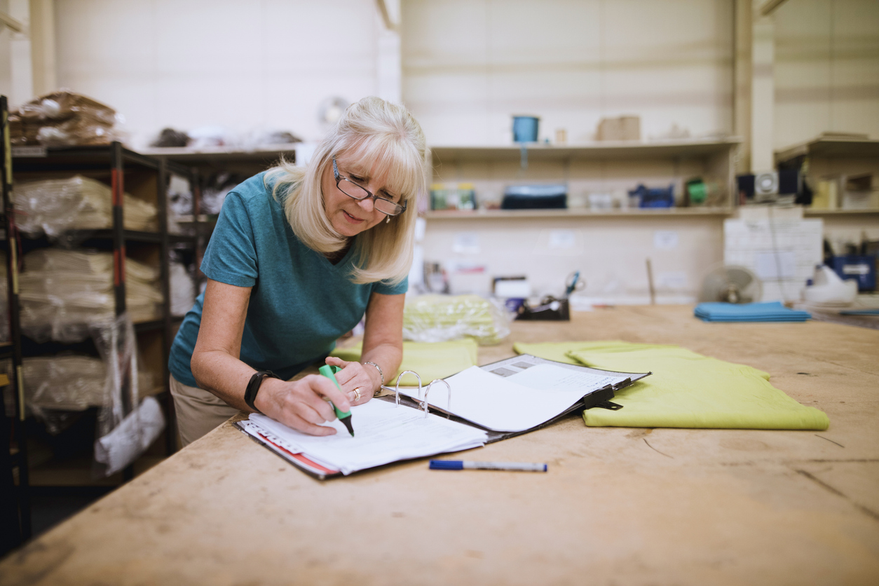 businesswoman doing paperwork in factory