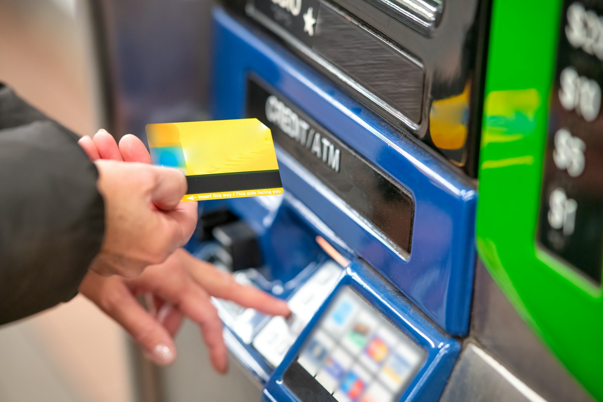 a person using a credit card to pay for a machine