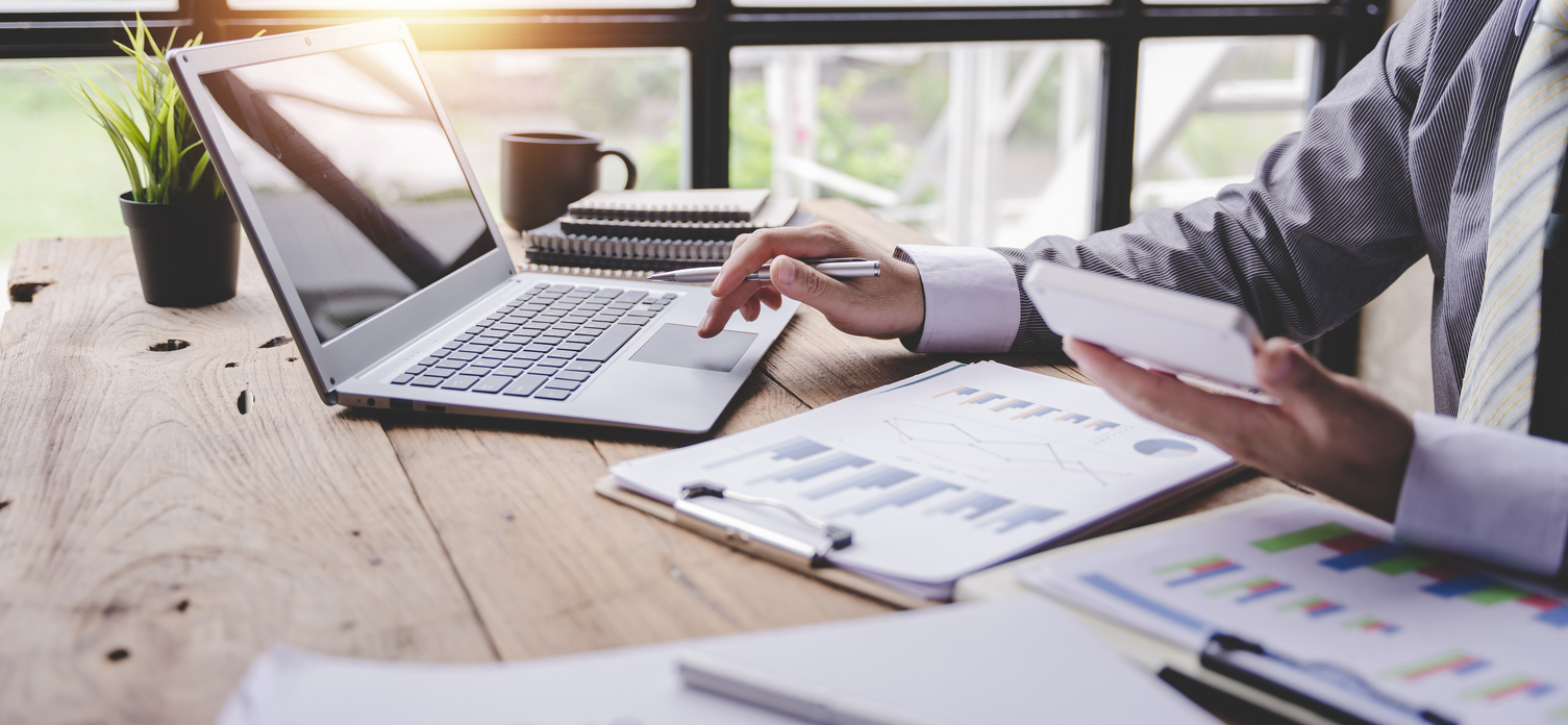 portrait of a businessman working on a tablet computer in a modern office. make an account analysis report. real estate investment information financial and tax system concepts